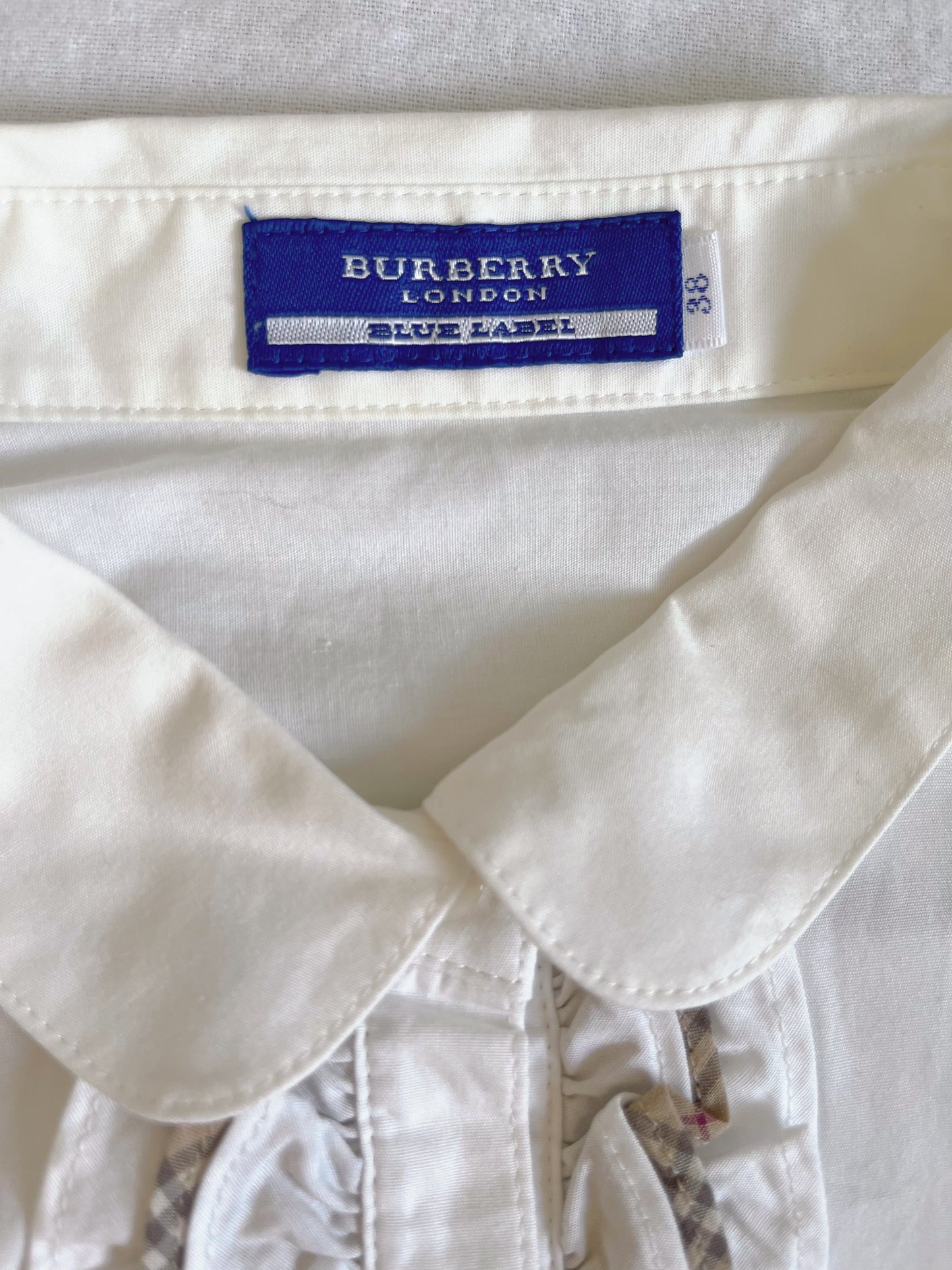 White Burberry ruffle shirt with a touch of preppy charm