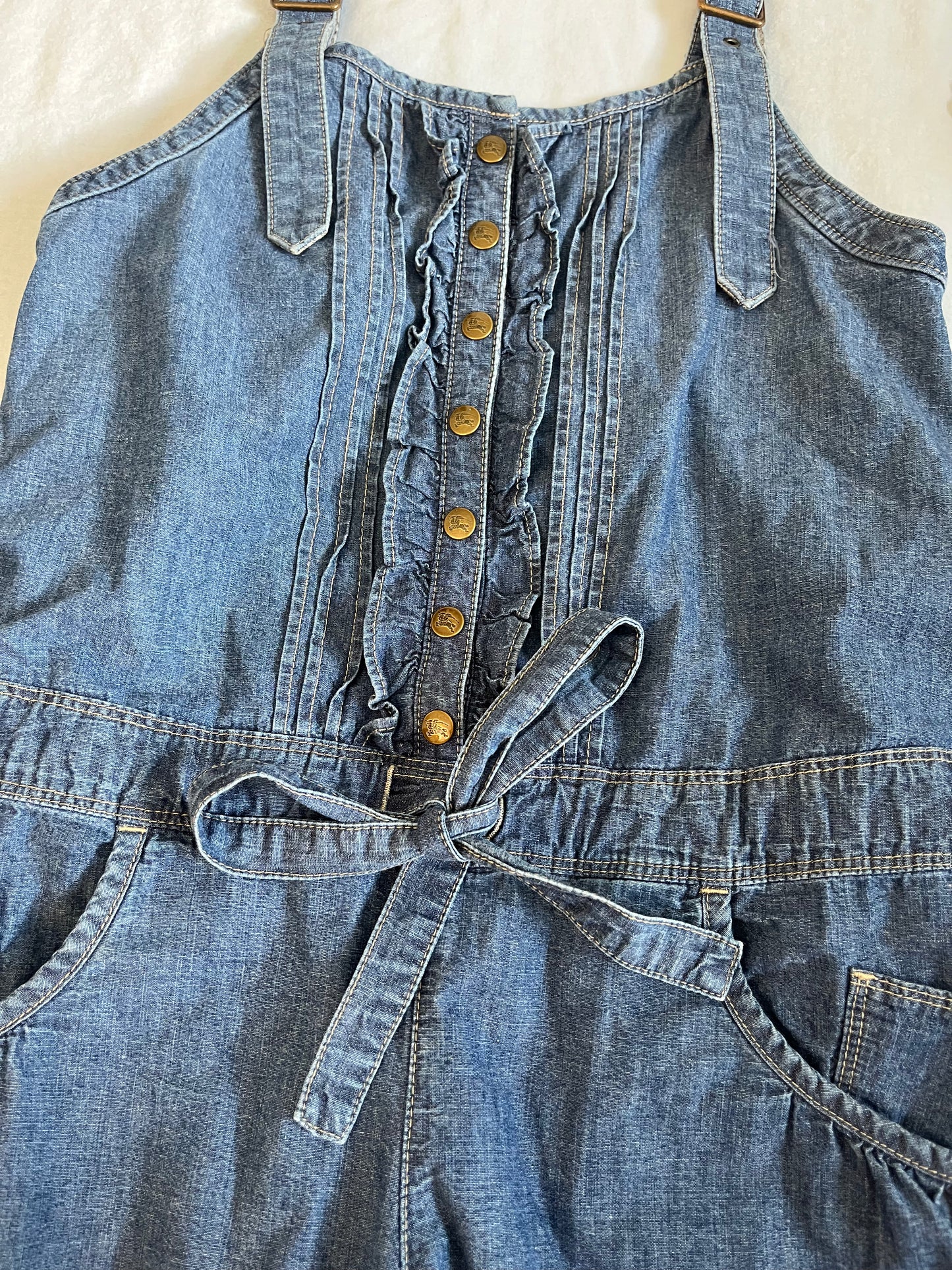 Blue denim romper with ruffles and frills