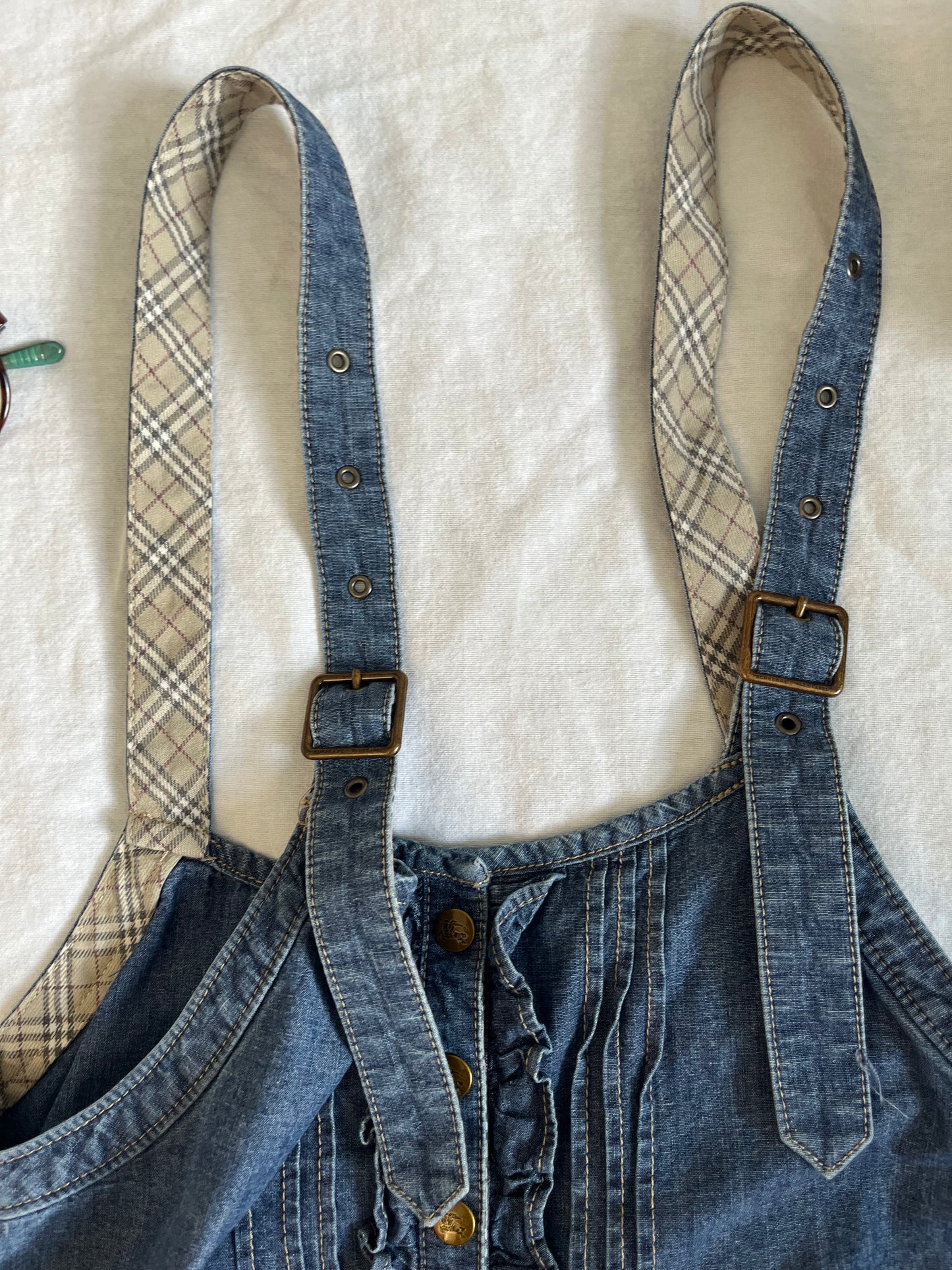 Blue denim romper with ruffles and frills