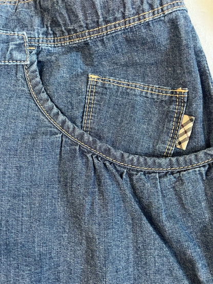 Blue denim romper with ruffles and frills