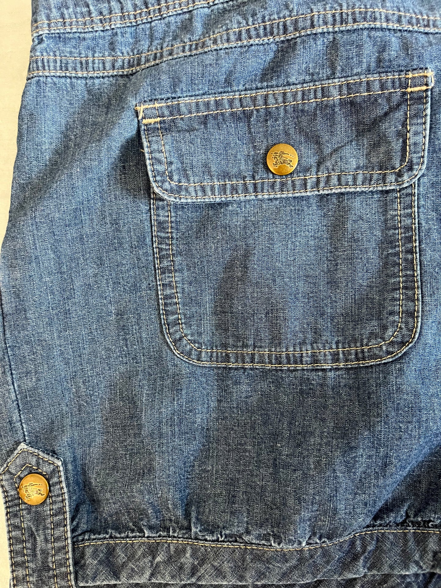 Blue denim romper with ruffles and frills